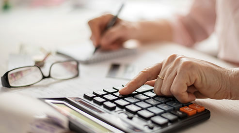 Woman calculating and writing