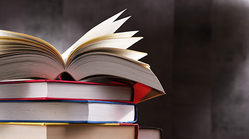 Open book on a stack of books